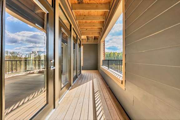 A balcony with wooden flooring and a view of the sky at Luxe 360 on Centerpointe Apartments, Virginia, 23114