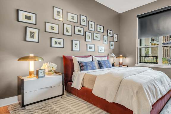 A bedroom with a large bed and a nightstand with a lamp at Luxe 360 on Centerpointe Apartments, Virginia, 23114