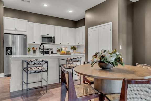 A kitchen with a table and chairs. at Luxe 360 on Centerpointe Apartments, Midlothian, VA, 23114
