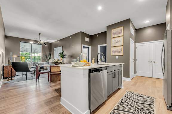 A modern kitchen with a dining table and chairs at Luxe 360 on Centerpointe Apartments, Virginia, 23114