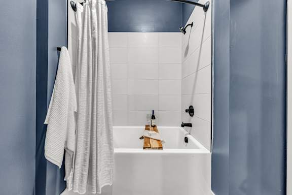 A white bathroom sink with a towel hanging on the wall at Luxe 360 on Centerpointe Apartments, Virginia