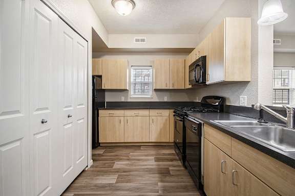 A kitchen with a window and hard surface flooring A kitchen with a window and hard surface flooring at Lynbrook Apartments and Townhomes, Elkhorn, NE, 68022