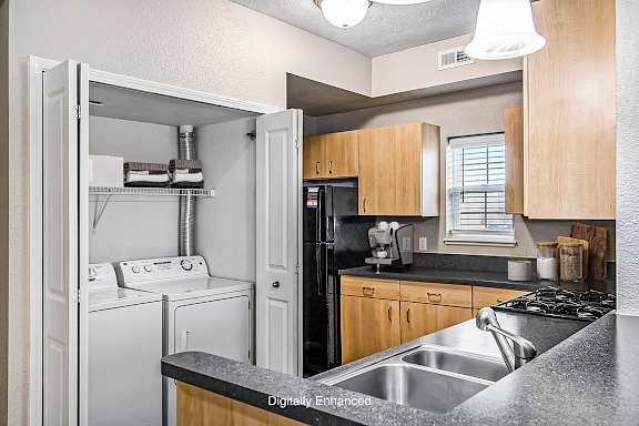 An end kitchen with a window and washer and dryer An end kitchen with a window and washer and dryer at Lynbrook Apartments and Townhomes, Elkhorn, NE, 68022