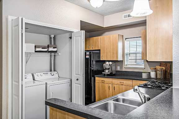 An end kitchen with a window and washer and dryer at Lynbrook Apartments and Townhomes, Elkhorn, NE, 68022