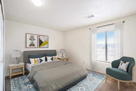 A bedroom with a large window and a bed at Madeira Apartments in Kalamazoo, MI 49001