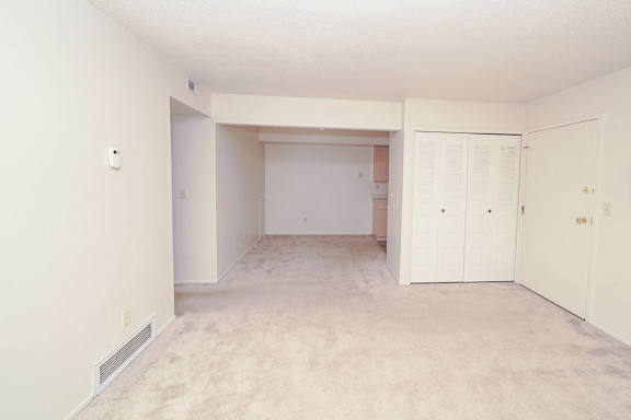 the living room and dining room of an empty house at Madeira Apartments, Kalamazoo, 49001