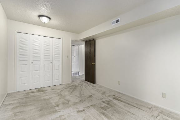 Bedroom with doors to a closet at Madeira Apartments, Kalamazoo, 49001