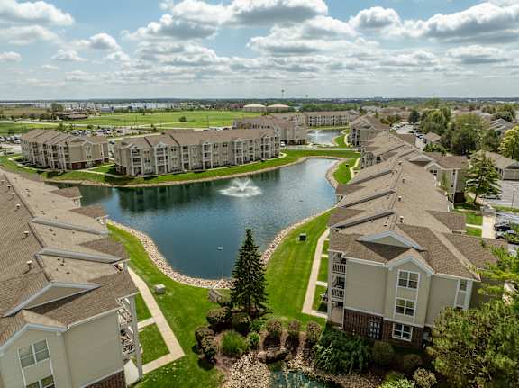 A large lake is surrounded by apartment buildings