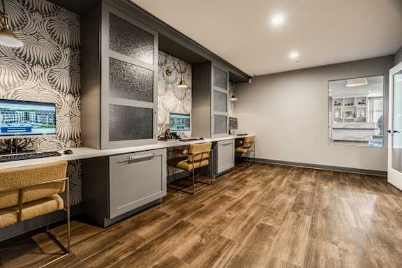 A modern kitchen with wooden floors and a patterned wallpaper