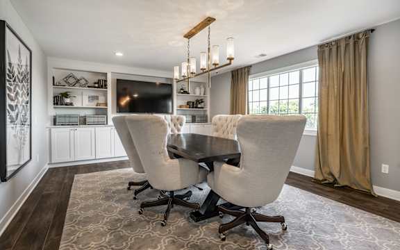 A modern dining room with a dark wood table and two chairs