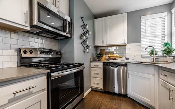 A modern kitchen with a stove, oven, and microwave