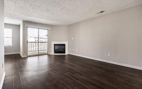 A spacious living room with a fireplace and sliding glass doors
