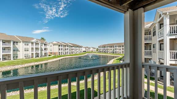 A row of apartment buildings with a body of water in front