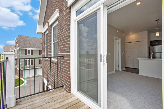 a sliding glass door in a home with a deck at Meadowbrooke Apartment Homes, Grand Rapids, MI, 49512