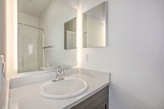a bathroom with a sink and a mirror at Meadowbrooke Apartment Homes, Grand Rapids, Michigan