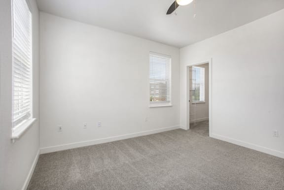 a living room with carpet and a door to a bathroom at Meadowbrooke Apartment Homes, Grand Rapids, Michigan