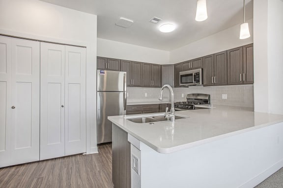 a kitchen with a sink and a refrigerator at Meadowbrooke Apartment Homes, Grand Rapids, 49512