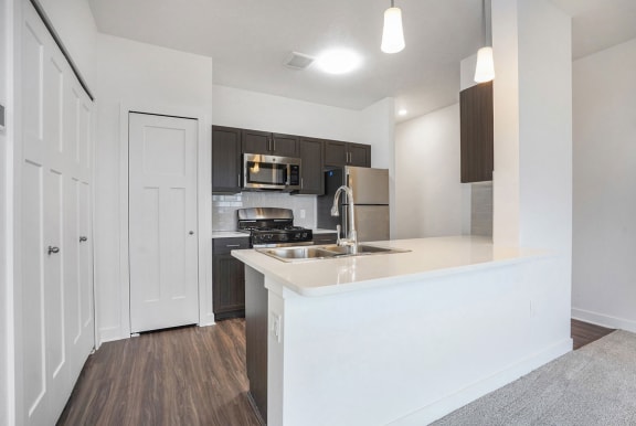 a kitchen with a counter top and a sink at Meadowbrooke Apartment Homes, Grand Rapids, Michigan
