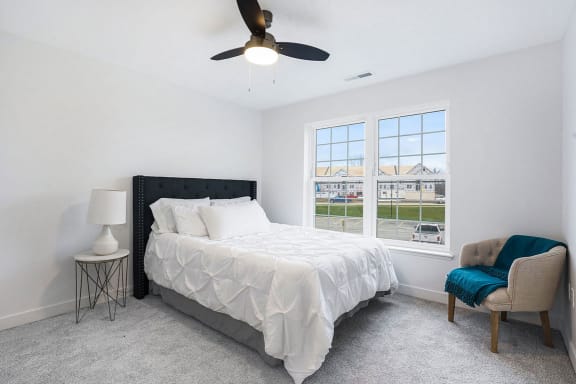 a bedroom with a bed and a ceiling fan at Meadowbrooke Apartment Homes, Michigan, 49512