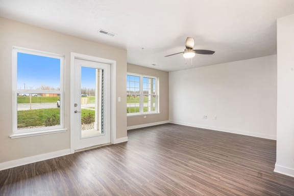 an empty living room with doors and a ceiling fan at Meadowbrooke Apartment Homes, Grand Rapids, MI, 49512