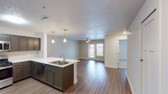an empty kitchen and living room with wood flooring and at Meadowbrooke Apartment Homes, Grand Rapids, MI