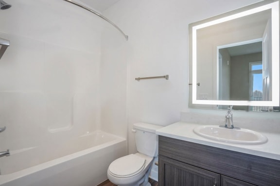 a bathroom with a sink toilet and a mirror at Meadowbrooke Apartment Homes, Grand Rapids, 49512