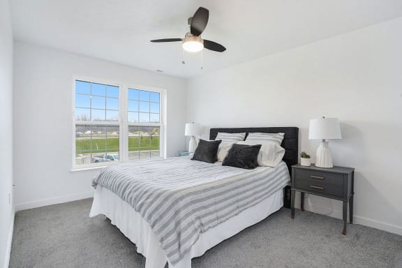 a bedroom with a bed and a ceiling fan at Meadowbrooke Apartment Homes, Grand Rapids, 49512
