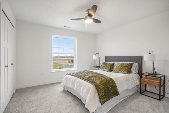 a bedroom with a bed and a ceiling fan at Meadowbrooke Apartment Homes, Grand Rapids, MI