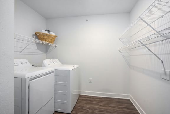 a laundry room with a washer and dryer and a white closet at Meadowbrooke Apartment Homes, Michigan