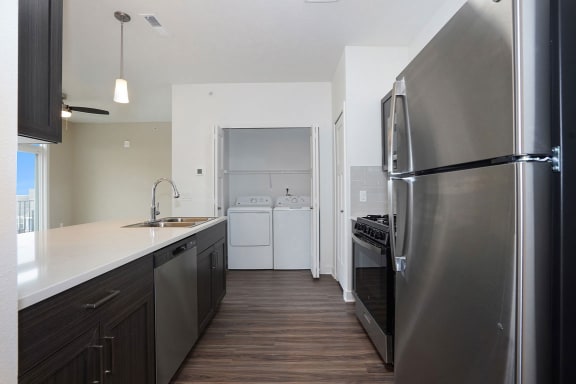 a kitchen with stainless steel appliances and a wooden floor at Meadowbrooke Apartment Homes, Grand Rapids, Michigan