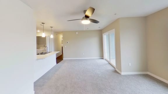 an empty living room with a ceiling fan at Meadowbrooke Apartment Homes, Grand Rapids, Michigan