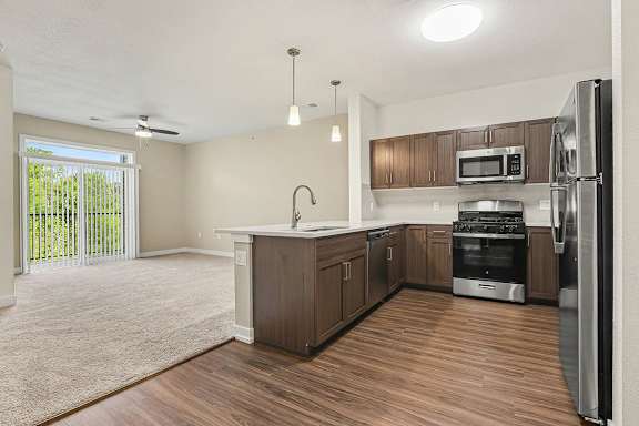 A kitchen with hard-surface floors and stainless steel appliances at Meadowbrooke Apartment Homes in Grand Rapids, MI 49512