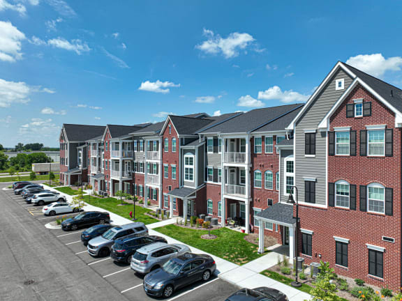 a row of apartments with a parking lot in the foreground at Montgomery Place Apartments, Montgomery