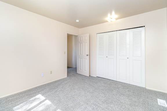 A bedroom with a large closet at Mount Royal Townhomes in Kalamazoo, MI