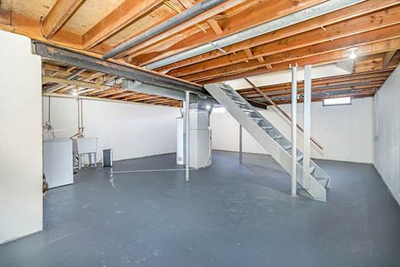 Private basement with a washer and dryer and storage space at Mount Royal Townhomes in Kalamazoo, MI