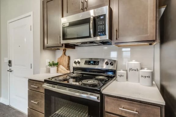 a kitchen with stainless steel appliances and white countertops at Montgomery Place Apartments, Illinois, 60538