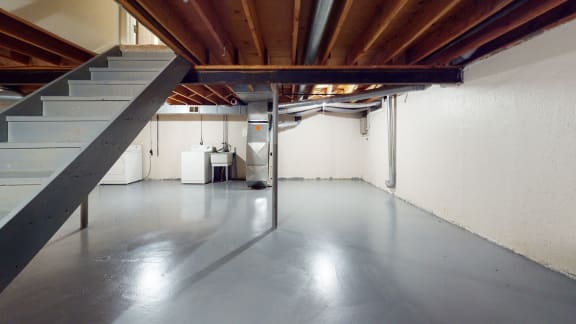 a large garage with a steel floor and stairs