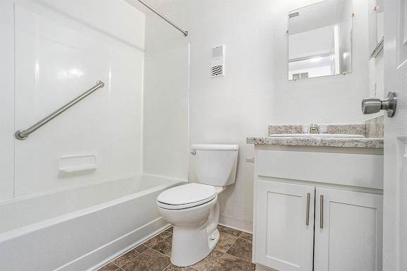 An upgraded bathroom with a shower and bathtub at Newport Village Apartments, Portage, MI