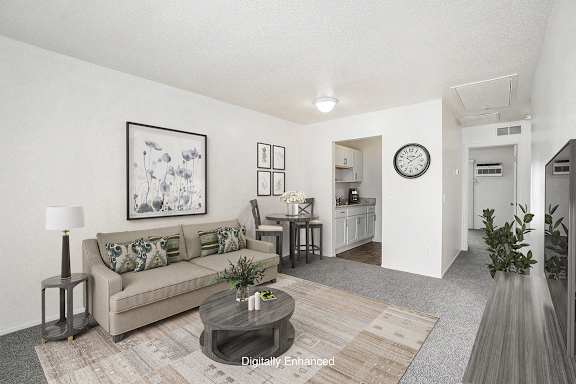 living and dining rooms to a kitchen with hard surface flooring at Newport Village Apartments, Portage, MI
