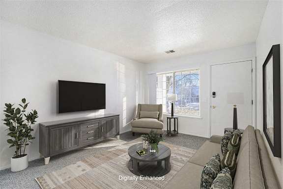 Main floor living with large window at Newport Village Apartments, Portage, MI