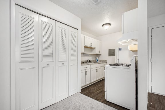 a white kitchen with white cabinets and white appliances a white kitchen with white cabinets and white appliances at Normandy Village Apartments, Michigan City, IN, 46360