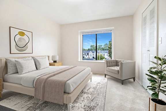 A bedroom with a large bed and a window at North Pointe Apartments, Elkhart