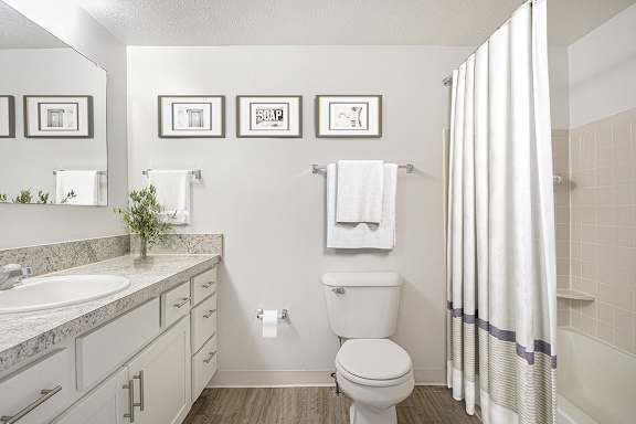 full bathroom with white cabinetry and hard surface flooring at North Pointe Apartments, Indiana, 46514