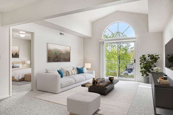 A living room with a cathedral ceiling and a half round window at North Pointe Apartments, Elkhart, IN, 46514