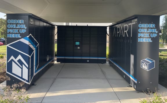 a pair of black lockers with white and blue lettering and a blue and white sign  at Northport Apartments, Michigan