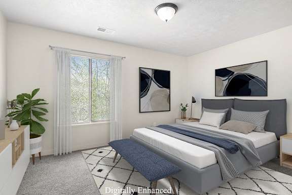 A bedroom with a large bed and a window with curtains at Old Farm Apartments, Elkhart, 46517