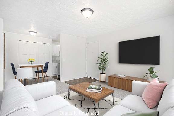 A modern living room leading to a dining room with a closet at Old Farm Apartments, Elkhart, 46517