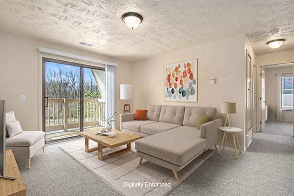 A living room with a couch, a coffee table, and a slider to a balcony Private Balcony or Patio at Old Farm Apartments in Elkhart, IN