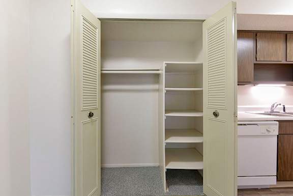 A white closet with large shelves at Old Monterey Apartments, Springfield, MO