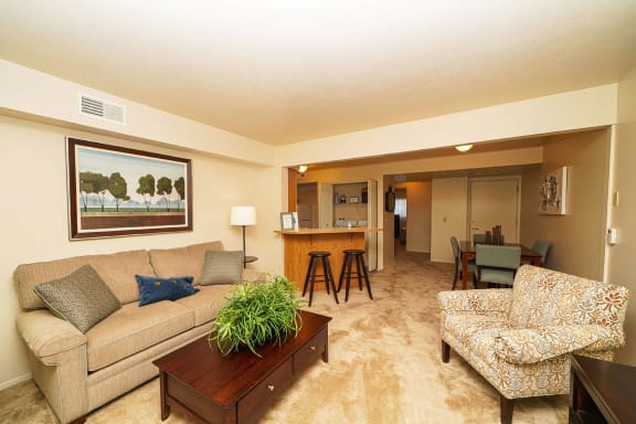 a living room with a couch and a table at Orchard Lakes Apartments, Ohio, 43615